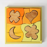 Bauspiel Gelb von Grimm's mit 12 Holzteilen im Rahmen