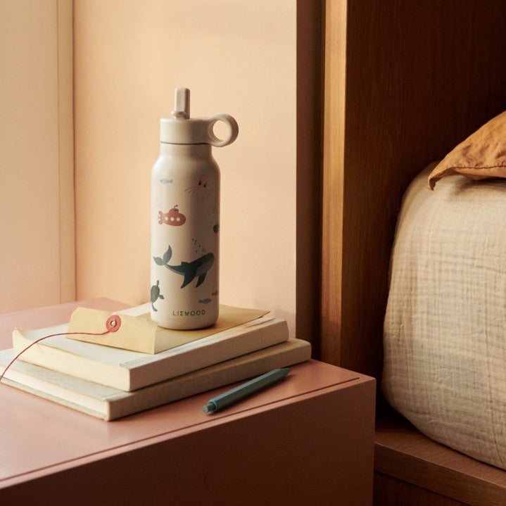 Liewood Trinkflasche Falk Modell Sea Creature an Bett stehend